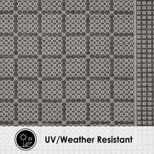 Close-up of gray and dark geometric square trellis pattern on area rug surface