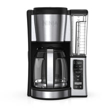 Black and stainless programmable coffee brewer with glass carafe and side water reservoir
