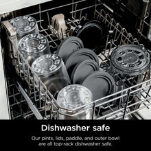 Dishwasher with clear pint containers, lids, and attachments on the top rack