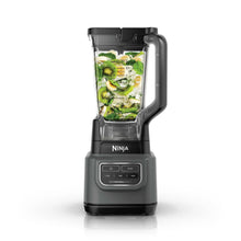 Dark gray blender with clear pitcher and lid, filled with leafy green smoothie ingredients