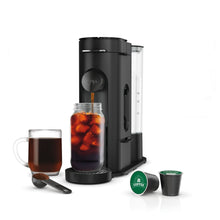 Black single-serve pod coffee brewer with iced drink jar, cups, and pod accessories.