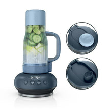Dark personal blender with clear blending jar, blue lid, and gray control panel.
