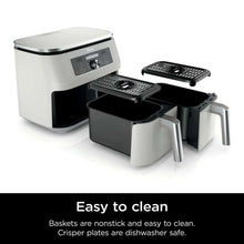Dual-zone air fryer appliance with split baskets and crisper plates exposed, white