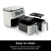 White dual-basket air fryer with two removable crisper baskets pulled out