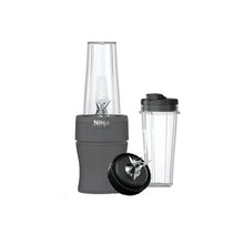Gray personal blender base with clear blending jar and black to-go cup lid