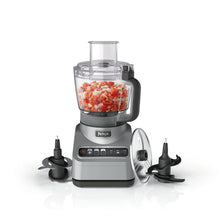 Gray countertop food processor with clear 9-cup bowl and multiple chopping blades