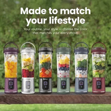 Set of personal blenders in multiple colors standing on a table outdoors