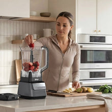 Ninja CRUSHiQ blender pitcher holding mixed fruit on base