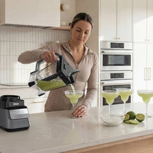 Ninja CRUSHiQ blender base with XL pitcher being filled with green smoothie