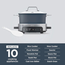 Multi-cooker with blue pot, lid, and white spatula accessory on display