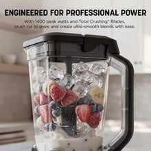 Silver blender pitcher filled with ice and mixed berries