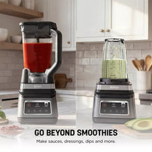 Two smoothie blender pitchers with red and green blends on stainless base