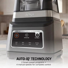 Stainless blender base with illuminated control panel and black blending buttons