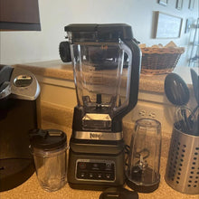 Countertop blender base with clear pitcher and included attachments