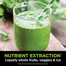 Green blended drink in a glass with smoothie texture and mint leaf garnish