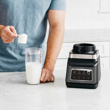Ninja blender DUO with clear cup of white liquid and black base