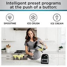 Countertop blender with clear pitcher, black base, and blending lid on top