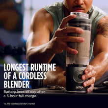 Cordless blender with clear cup held above a countertop, Ninja branding on base.