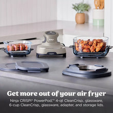 Gray and black portable air fryer base with two clear cooking containers on counter