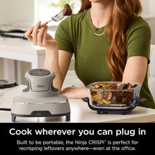 Portable air fryer on countertop with person serving food from a clear container