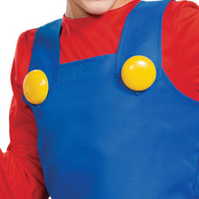 Blue overalls with yellow buttons over red sleeves, close-up