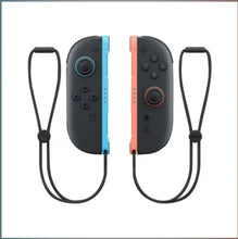 Joy-Con L/R controllers with light blue and light red rails, black grips, two straps