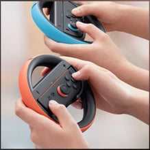 Hands holding Joy-Con wheels, one blue and one orange with black controls