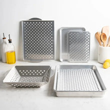 Perforated stainless steel crisping trays set with square and rectangular grid inserts