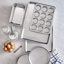 Stainless steel bakeware set with loaf pan, muffin tin, and round cake pan