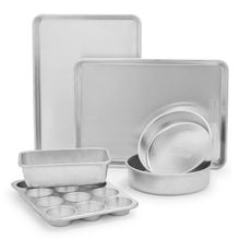 Stainless steel bakeware set with rectangular pans, muffin tray, and round cake pan