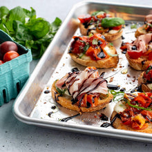 1/6 aluminum sheet pan with toast topped with vegetables and herbs