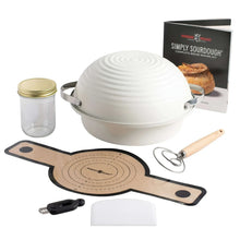 Sourdough starter kit with white cloche, glass jar, baking board, and tools
