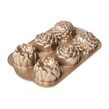 Gold mini bundt pan with six wildflower-style molded cake cavities
