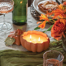 Orange ceramic pumpkin candle, two wicks lit