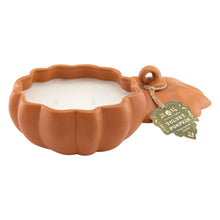 Orange ceramic pumpkin candle dish with unlit melted wax center