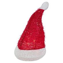 Santa hat tree topper with red fuzzy cone, white brim and gray pom, warm clear lights