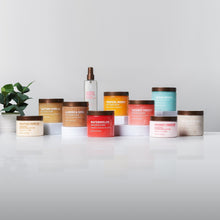 Assorted body care containers on a surface, including a Tahitian Vanilla jar
