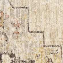 Runner rug close-up with distressed pattern and faded accents in light gray and ivory
