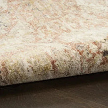 Runner rug close-up with beige, gray, and muted orange speckled texture