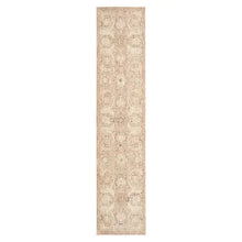 Runner rug with narrow vertical beige field and ornate faded motif
