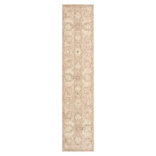 Beige runner rug with narrow border and distressed ornamental motif, rectangular