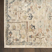 Runner rug border close-up with geometric block pattern in beige, blue, and rose