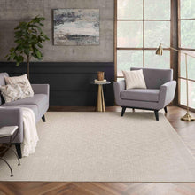 Light beige rectangular area rug with fine textured surface and border