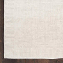 Ivory textured area rug close-up with raised loop-like surface