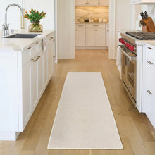 Rectangular beige area rug with subtle allover raised pattern