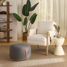 Dark gray woven looped pouf ottoman with tan leather side handle strap