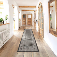 Indoor/outdoor runner rug with black-and-white lattice pattern and border.