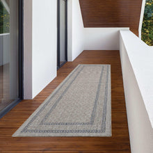 Meadow gray indoor/outdoor rug runner with centered border stripe on wood floor