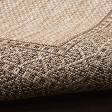 Indoor/outdoor rug texture closeup with tight woven beige and taupe loops