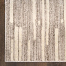 Runner rug close-up with light beige and gray vertical blocks pattern on ground